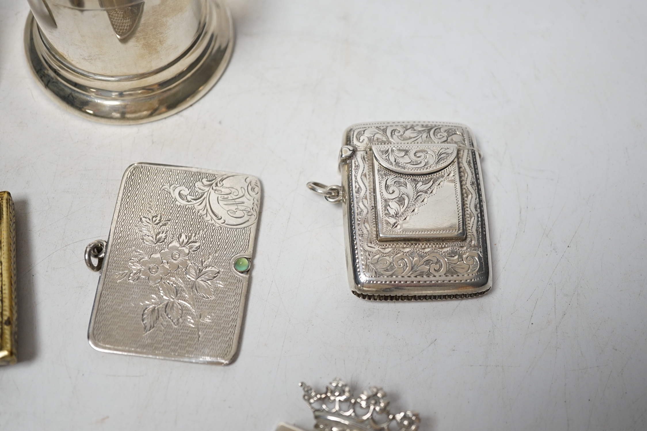 An Edwardian engraved silver combination stamp box/vesta case, Birmingham, 1906, 48mm, a similar silver slide action stamp case and seven other items including white metal box and sterling dispenser, etc.